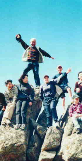 Nishizawa making a pose on rocks